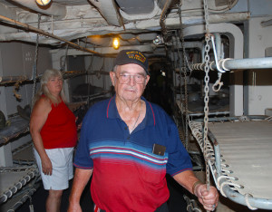 Claude Erwin, a World War II Veteran, standing in the area of the USS LST 325 where the Army bunked while being transported to Normandy, France on D-Day. Also pictured is Linda Erwin. (Photo by Chris Erwin)