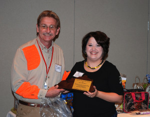 Tom Clay presents the KOPA Host award to Joy Brown, executive director of Morehead Tourism. (Photo by Chris Erwin)