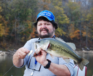 Author Chris Erwin holding a 22 1/2 inch bass and displaying the lure that many of his fish were caught on. (Photo by Hershell Crum)