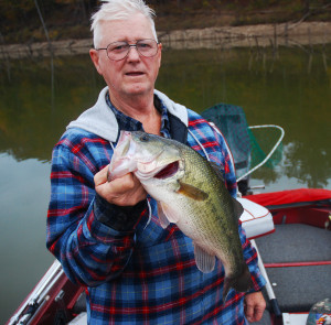 Hershell Crum displaying a 19 inch bass caught on Cave Run Lake. (Photo by Chris Erwin)