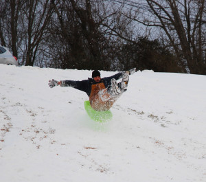 While the snow is unwanted by many, some of us are making the best of it. The picture is of the author's neighbor playing in the snow. (Photo by Chris Erwin)