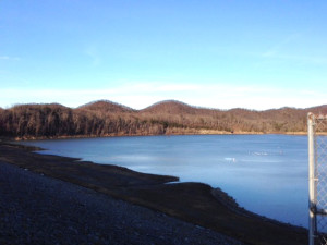 Cave Run Lake was still frozen in this photo taken on  Feb. 20. However, blue was returning to the thinning ice and by Sunday the ice had broken up enough that boats were back on the water for the first time in weeks. (Photo by Scott Doan)