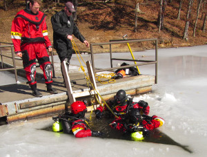 Members of the Ashland Fire Department Dive Team during an ice diving training exercise at Greenbo Lake. Pictured here are: Jared Chamberlin and Jarrod Duncan (on dock) with Carl Stambaugh, Evan Allison and Dustin Charles in the water preparing for a dive. (Photo courtesy of AFD).