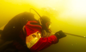  Ashland Fire Capt. Keith Salmon under the ice during a training exercise at Greenbo Lake State Resort Park last week. For safety divers are connected to a line, which is also used as a communication device to talk to other divers and rescuers on the surface. (Photo courtesy of the AFD). 