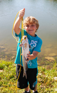 Dawnson Slone holding one of his catfish caught at the Kids Fishing Derby. (Photo by Chris Erwin)