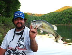 Author Chris Erwin holding one of the bass caught post spawn on Cave Run Lake. (photo by Scott Erwin)