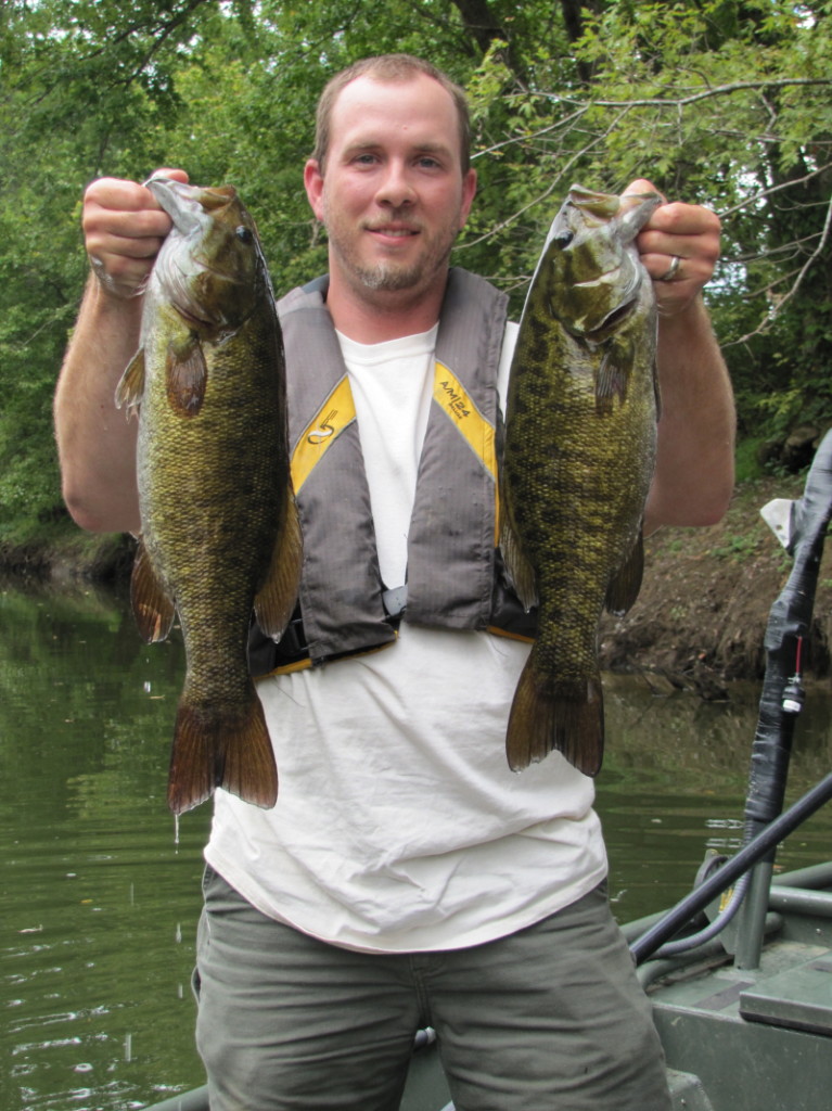 David Baker, stream fisheries biologist for the Kentucky Department of Fish and Wildlife Resources, holds two healthy smallmouth bass collected from the Barren River. Kentucky offers bountiful stream smallmouth bass fishing opportunities and wading is an economical and highly productive way to catch them. Unlike many forms of fishing, stream smallmouth fishing peaks in summer.  