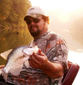 Author Chris Erwin holding a crappie caught on Licking River some 10 miles from the main lake photo by Bill Brainard