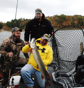 Justin Mullins displays a 42½-inch Muskie caught while guiding two fishermen from Michigan on Saturday Oct. 18. The fish was released. (Photo by Chris Erwin)