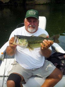 Steve Crum, of Greenup Ky., holding one of a dozen bass caught on Grayson Lake in the last few weeks.  (photo submitted)