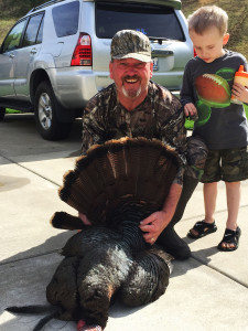 Dan Feltner, along with his grandson Will, admiring his turkey taken the first day of the season near his farm in Paintsville, Ky. (photo submitted)                  