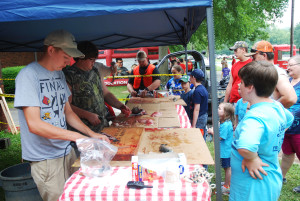 Volunteers clean the children’s catches on Saturday. (Photo by Chris Erwin)