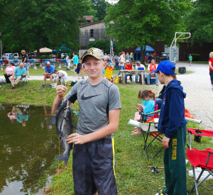 Logan Harrison, of Russell, holds his catch while participating in the Cave Run Kids Fishing Derby. (Photo by Chris Erwin)