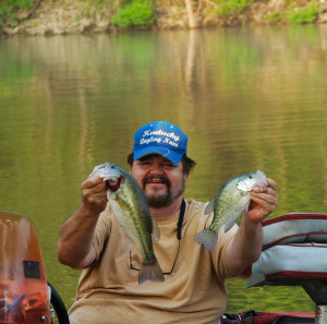 Author Chris Erwin holding an Largemouth Bass and a Crappie he caught last week on Cave Run Lake using the method described in last week’s column, — crankbaits fishing points and shore lines. (Photo by Scott Erwin)