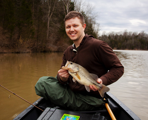 Obie Williams, graphic designer for the Kentucky Department of Fish and Wildlife Resources, holds a fat largemouth bass caught last week from a murky small lake in Owen County. March is prime time to fish farm ponds and small lakes for largemouth bass, bluegill and catfish as their shallower waters heat up quicker than large, sprawling reservoirs. 