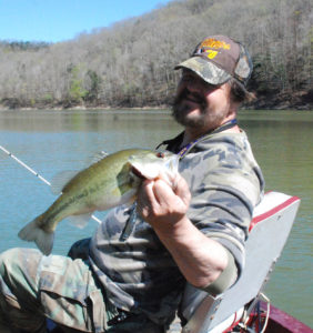 Author Chris Erwin holds one of the bass caught two weeks ago fishing points on Cave Run Lake. (photo by Scott Erwin)