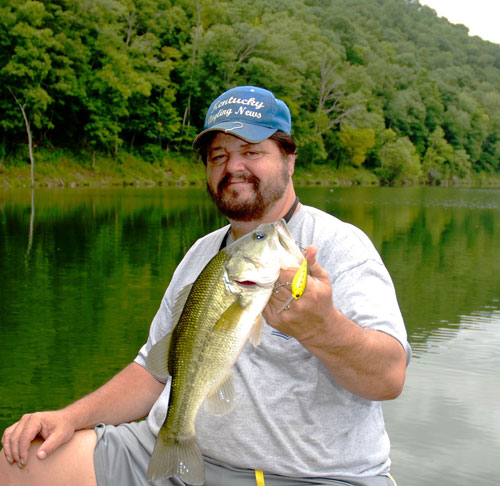 Author Chris Erwin holding a bass caught on Cave Run in July fishing the "Milk Run"